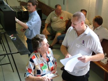 Ian Nel and Val Nagel discuss an issue while judging continues in the background.