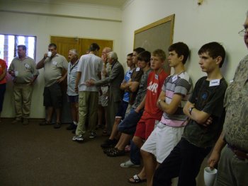 Exhibitors and stewards wait for the judging to start.