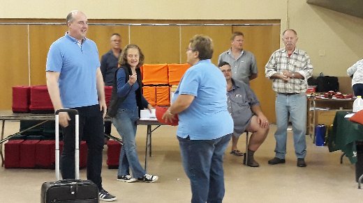 Frank Nietgen getting ready to catch a raffle ticket for the suitcase in front.