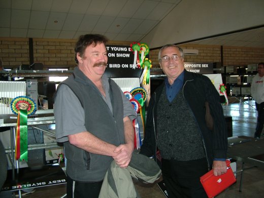 Ian Bleasdale and Malcolm Taylor of Bleasdale, Taylor & Wright in front of the Best Bird on Show at the SA National Championship Show 2015