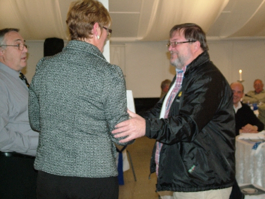 Koos du Preez receives his awards from Maja Swart while Malcolm Taylor looks on.