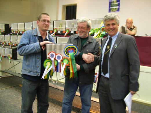 Molkentin Stud, Holger and Reinhard Molkentin, being congratulated on winning Best Bird on Show by Maurice Roberts.