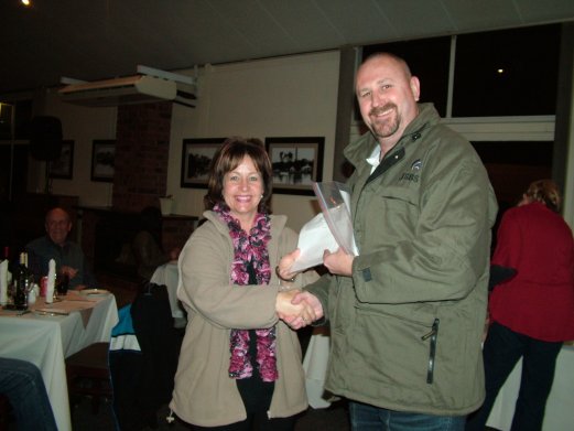 Ian Nel, Nel Brothers Stud, receives the Challenge Certificate for Best Dark and Olive Green on Show from Elke de Witt.