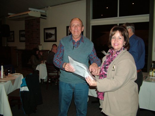 Heino Artus receives the Challenge Certificate for Best Cinnamon Green Series and Recessive Pied on Show from Elke de Witt.