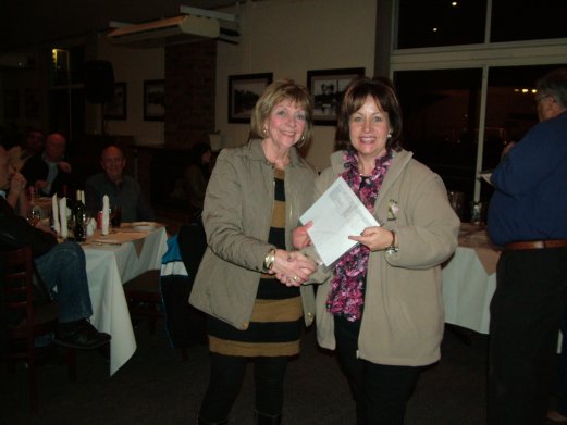 Jeanette Fouche receives the Challenge Certificate for Best Greywing, Clearwing, Yellow and White on Show as well as Best Any Age on Show from Elke de Witt.