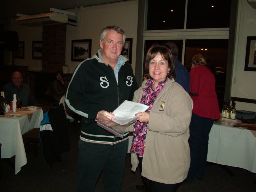 Russel Clements receives the Challenge Certificate for Best Opaline Green Series on Show from Elke de Witt.