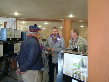 Members gather around the for sale birds which were in the middle of the staging area.